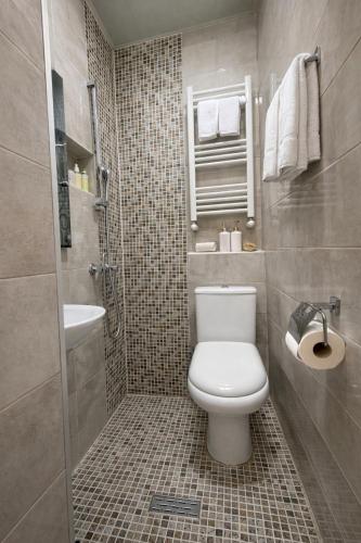 a bathroom with a toilet and a sink and a shower at DavidL Hotel Tbilisi in Tbilisi City