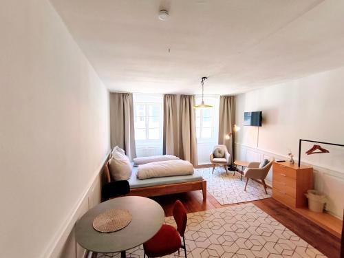 a living room with a bed and a table at Globetrotter Apartments in Konstanz
