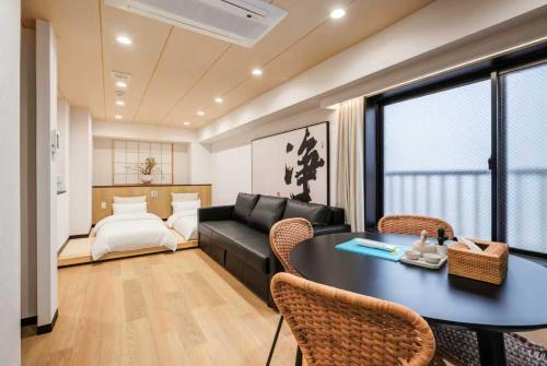 a living room with a black table and a couch at YCYC Hotel in Tokyo