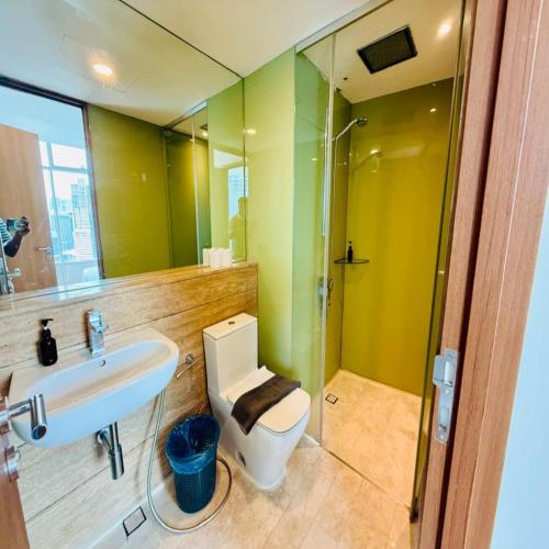 a bathroom with a toilet and a sink and a shower at Vortex by klcc view in Kuala Lumpur