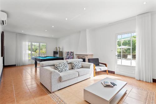 a living room with a couch and a table at Quinta da Lu - Azorean Villa in Ribeira Grande