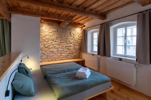 a bedroom with a bed and two windows at Königův mlýn in Úštěk