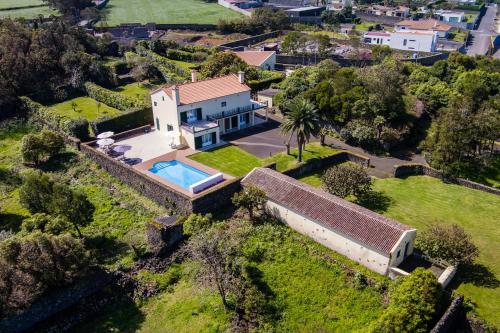 an aerial view of a house with a swimming pool at Quinta da Lu - Azorean Villa in Ribeira Grande