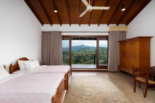 a bedroom with a bed and a large window at Villa Subashri, Victoria Golf Greens - Digana in Kandy