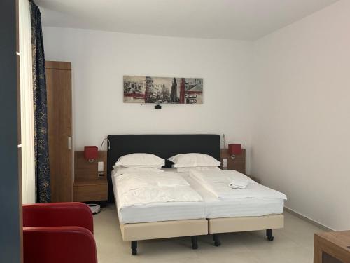 a bedroom with a bed with white sheets at La Romică in Mediaş