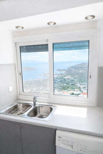 a kitchen with a sink and a window at SeaScapeHome Serifos in Serifos Chora