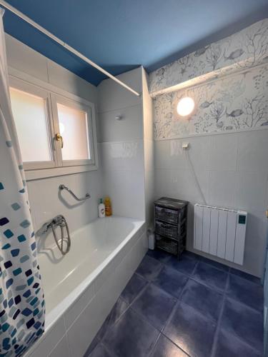a bathroom with a bath tub and a window at AL SON DE LAS OLAS in Lastres