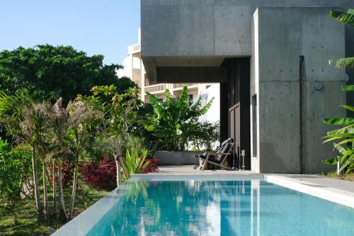 a swimming pool in the backyard of a house at 百momo in Nanjo