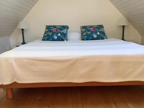 a bed with two pillows on top of it at Penty in Crozon