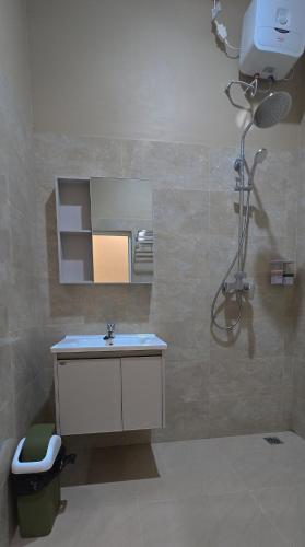 a bathroom with a sink and a mirror at Hotel Tian in Nabire