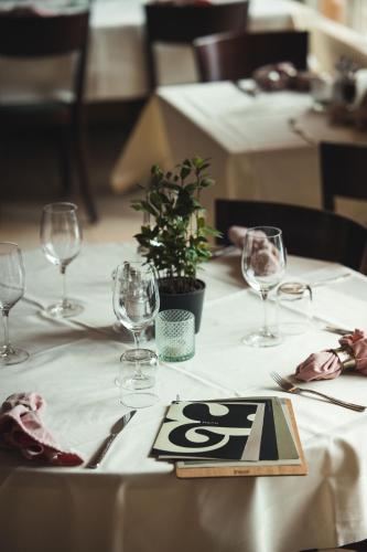 a table with a white table cloth with wine glasses at Hotel Victoria Lauberhorn Wengen, a Faern Collection Hotel in Wengen