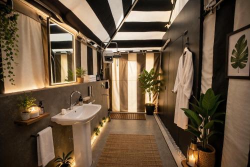 a bathroom with a sink and some plants in it at Badi Meadows By Wilkisto Near Fatehsagar Lake in Udaipur