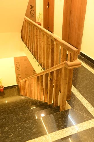 a wooden staircase in a building with a stair case at Hotel KK Place in Chittaurgarh