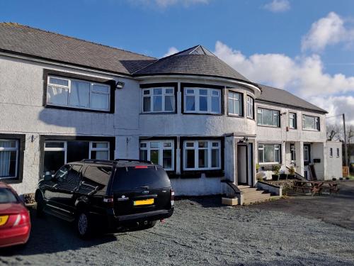 a black suv parked in front of a house at Windsor Local in Haverfordwest