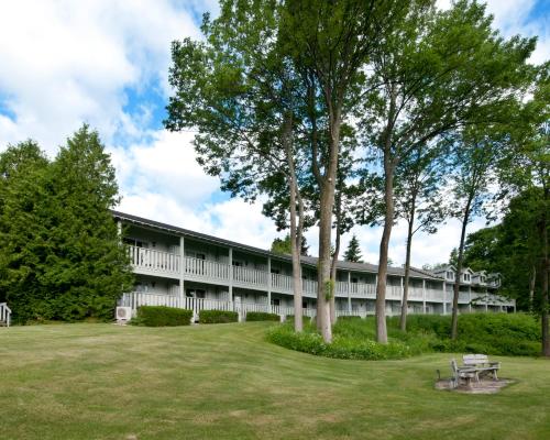 a building with a park in front of it at Country House Resort in Sister Bay