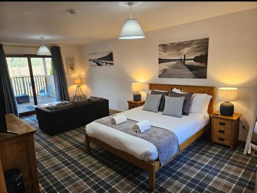 a bedroom with a bed and a living room at Letterfinlay Lodge House in Letterfinlay