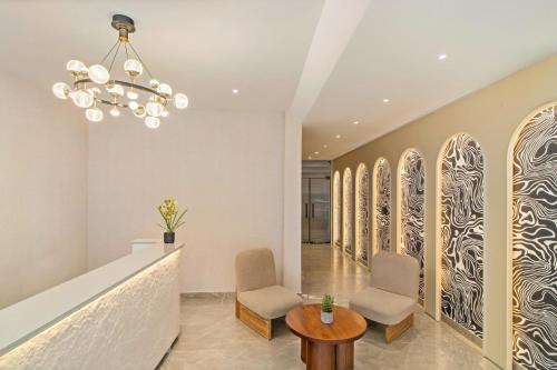 a lobby with chairs and a table and a chandelier at Country Inn Smart Stays, Rishikesh at Tapovan in Rishīkesh