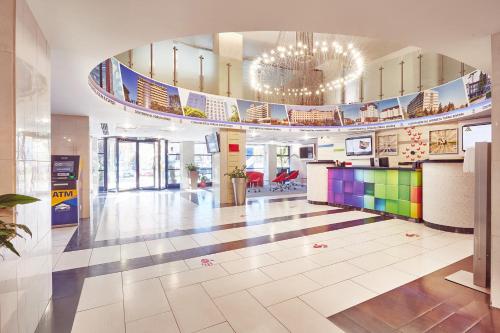 a large lobby with a brightly colored floor at MyContinental Sibiu in Sibiu