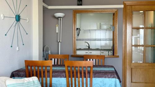 a dining room with a table and chairs and a mirror at La Llongada 2-C in L'Escala
