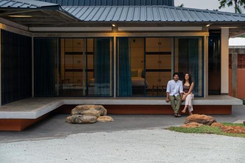 a man and a woman standing in front of a house at Sanctuary Amaidiyana - A CGH Earth Experience in Pondicherry