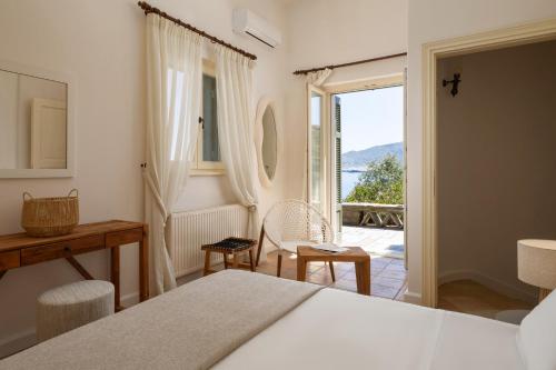 a bedroom with a bed and a view of the ocean at Horizon Beach House by Andros Villas Collection in Andros