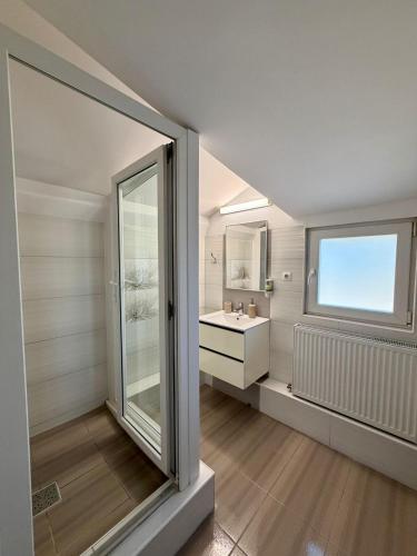 a bathroom with a sink and a window at ILSA Properties in Craiova