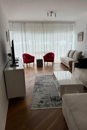 a living room with a couch and a table at Tre Canne Vista in Budva