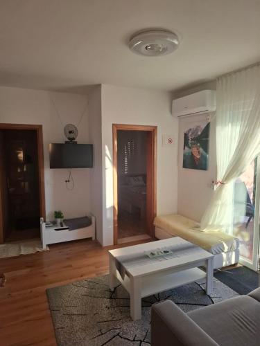 a living room with a couch and a coffee table at Apartman Mirjana in Mlini