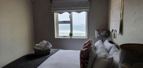 a bedroom with a bed with a view of the ocean at CUTTY SARK in Langstrand