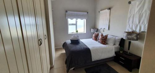 a bedroom with a bed and a window at CUTTY SARK in Langstrand