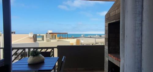 a vase sitting on a blue table on a balcony at Dolphin View 20 @ LongBeach in Langstrand