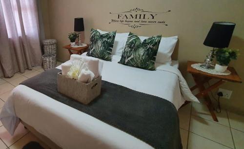 a bedroom with a white bed with a box on it at Dolphin View 20 @ LongBeach in Langstrand
