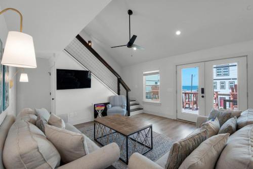 a living room with a couch and a table at Steps to the Beach 3BR Coastal Home Sleeps 10 in Port Saint Joe