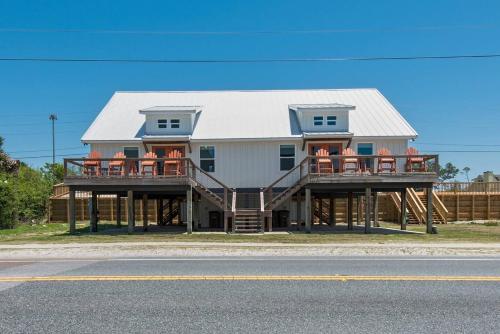 a large house with two decks and a gambrel roof at Beachfront 6BR Retreat w Gulf Views Sleeps 16 in Port Saint Joe