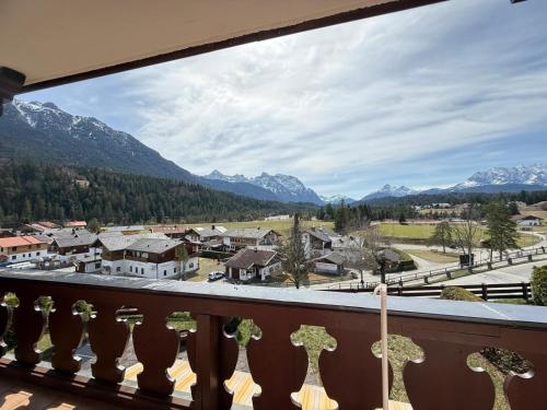 a balcony with a view of a town and mountains at Abendsonne in Krün