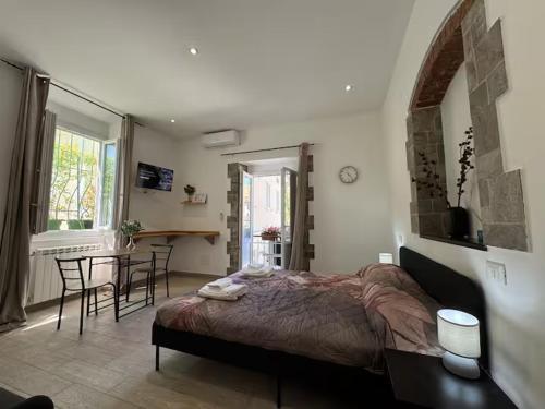 a bedroom with a bed and a table and chairs at SOBBORGO 34 - Affittacamere - in Sarzana