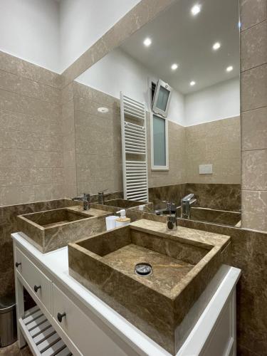 a bathroom with two sinks and a large tub at Suite 55 in Trani
