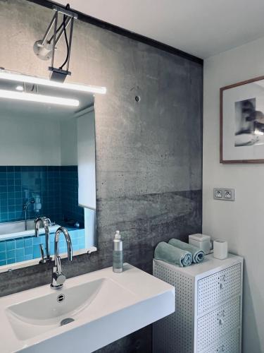 a bathroom with a sink and a mirror at LA PORTE ROUGE RBX in Roubaix