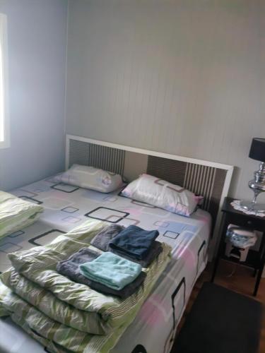 a bedroom with a bed with clothes on it at Paradis in Nord-Lenangen