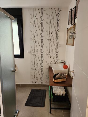 a bathroom with a sink and a mirror and a window at Splav La-familia in Umka