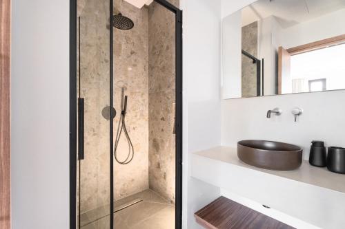 a shower with a glass door in a bathroom at Képos Villas Sivota in Syvota