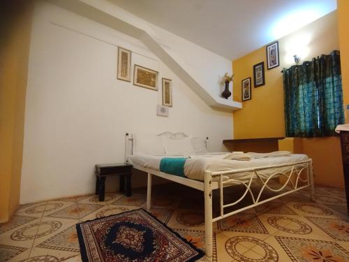 a bedroom with a white bed in a room at NEW BEACH HOTEL Anjuna in Anjuna