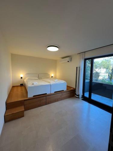 a bedroom with a white bed and a large window at Forest Haus in Schlangenbad