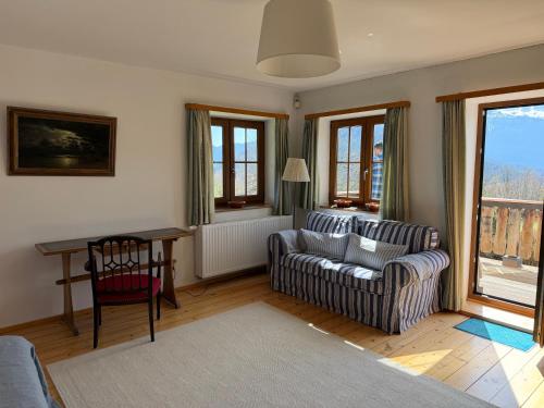 a living room with a couch and a chair at Nusshof in Berchtesgaden