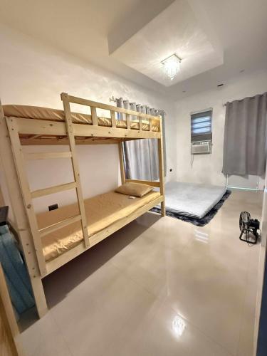 a room with two bunk beds in it at Modern Loft-Balcony-FullAC open space in Calumpit