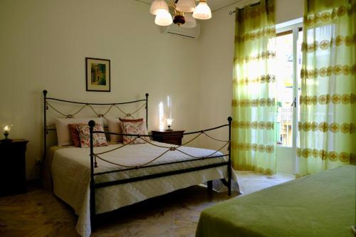 a bedroom with a bed and a window at Antonella's house in Casteldaccia