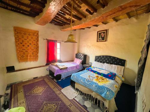 a room with a bed and a couch in it at Riad Bouchra in Tinerhir