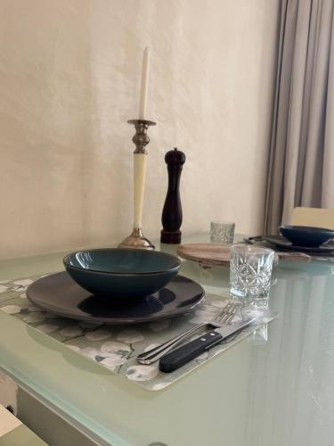 a table with a bowl and a candle on it at Studio Jordaan Amsterdam City Centre in Amsterdam