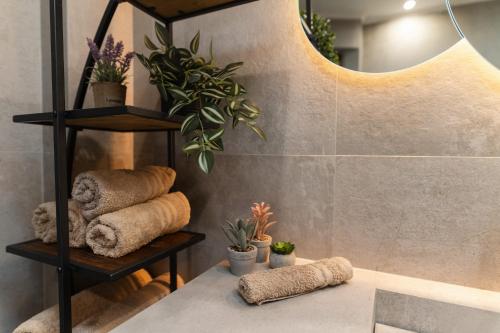 a room with a table with towels and plants at MariZot Apartment in Alexandroupoli