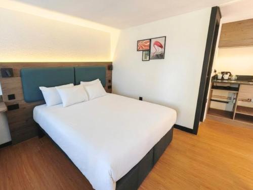 a bedroom with a large white bed in a room at The Crossway Hotel, Coventry Walsgrave, Part of AG Collection in Coventry